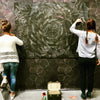 claire burbridge and Juliette ravon working on an installation of sea grape wallpaper fir her 2017 show at nancy toomey fine art in San Fransisco